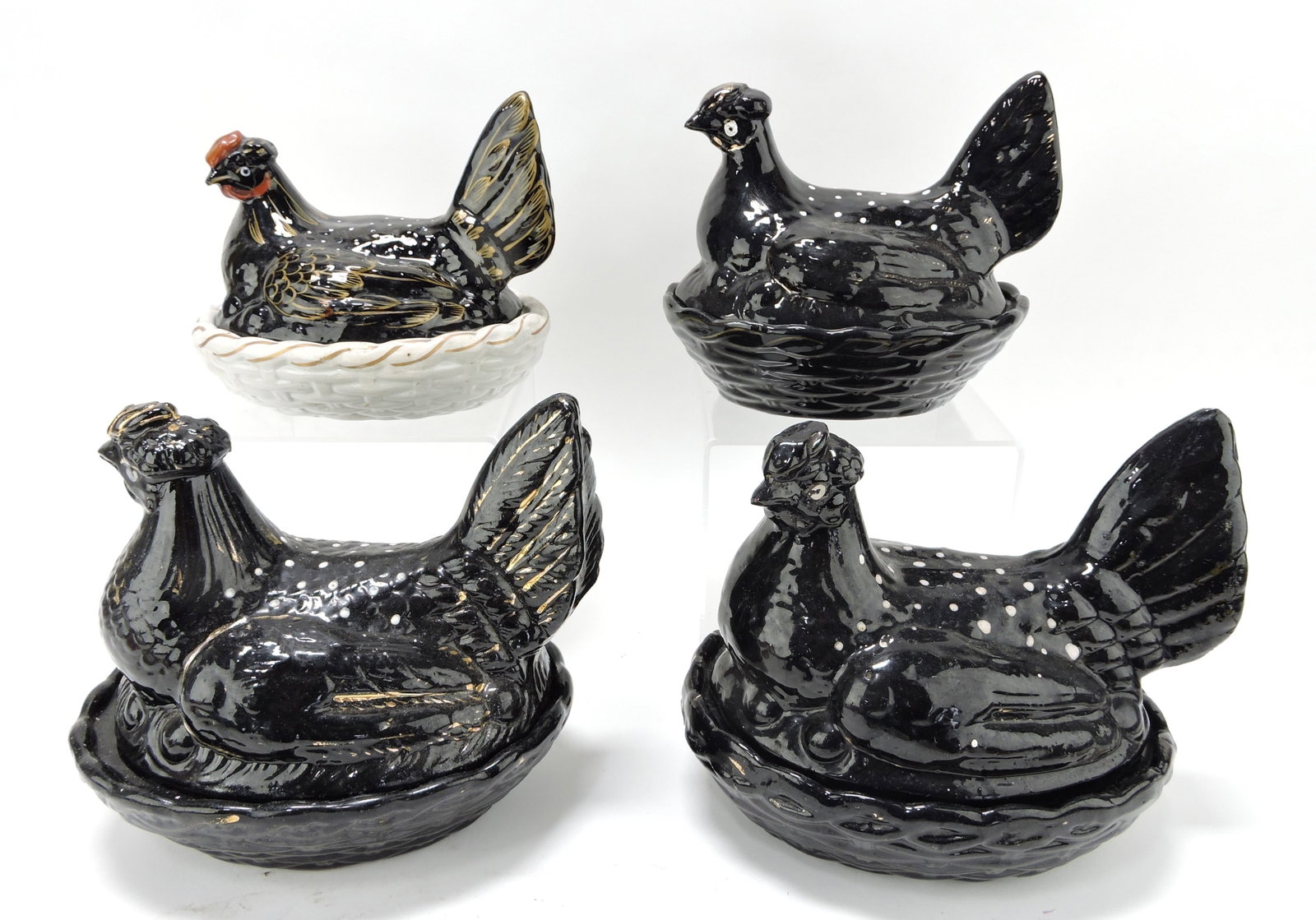 Staffordshire lot of 4 black hens on: nests, 5 1/2 to 8"