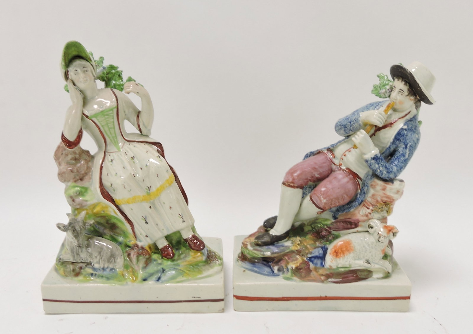 Staffordshire Pearlware pair of figures: of boy and girl with goats, 8"
