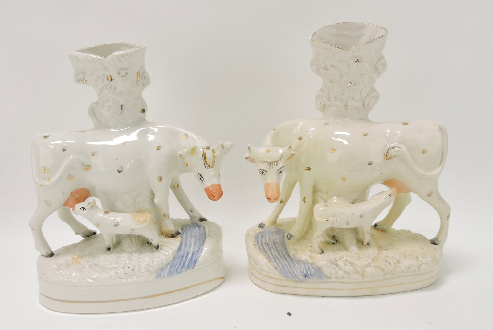 Staffordshire pair of cow spill vases,: 10"