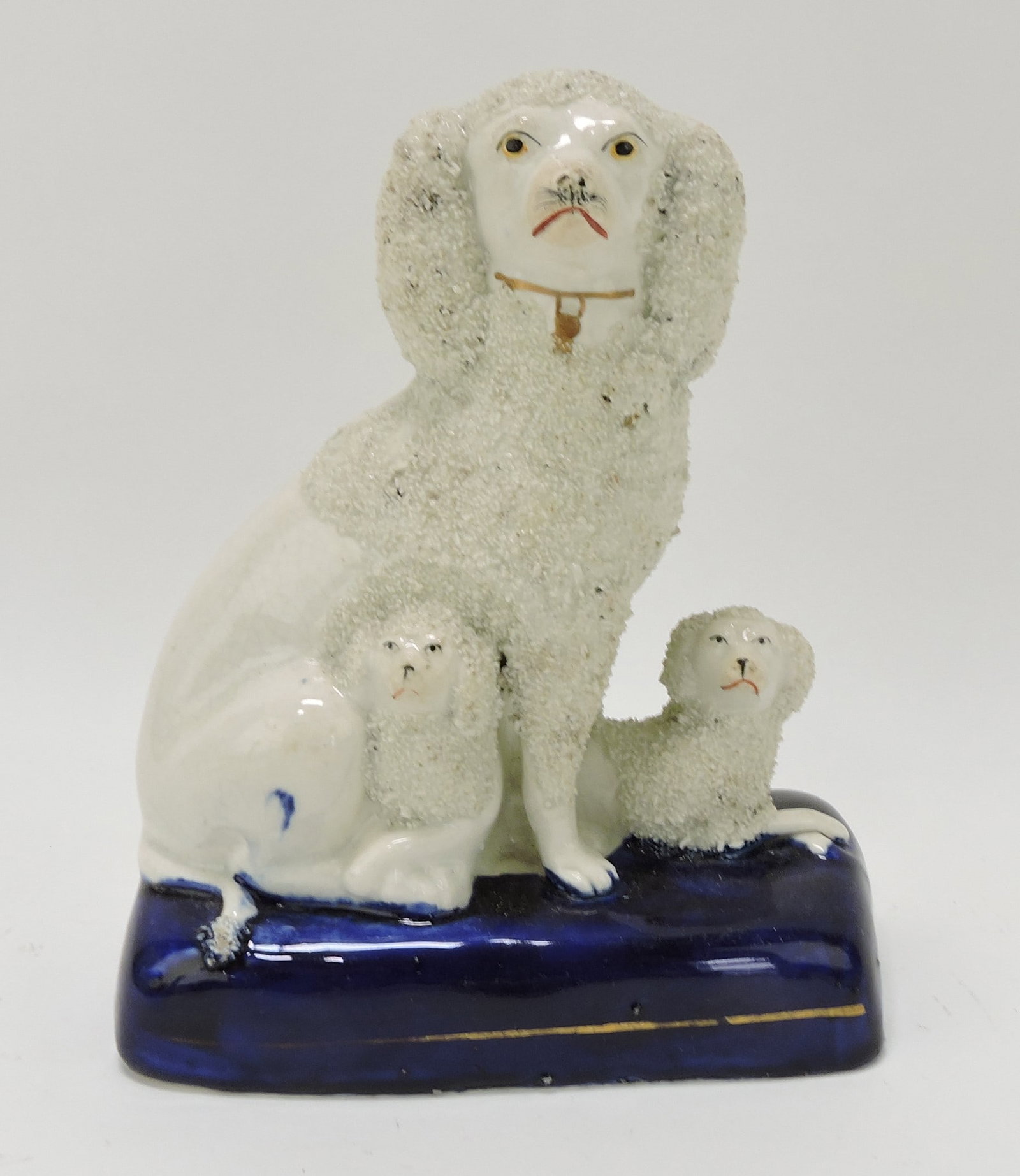 Staffordshire poodle with pups on: cobalt base, 8"