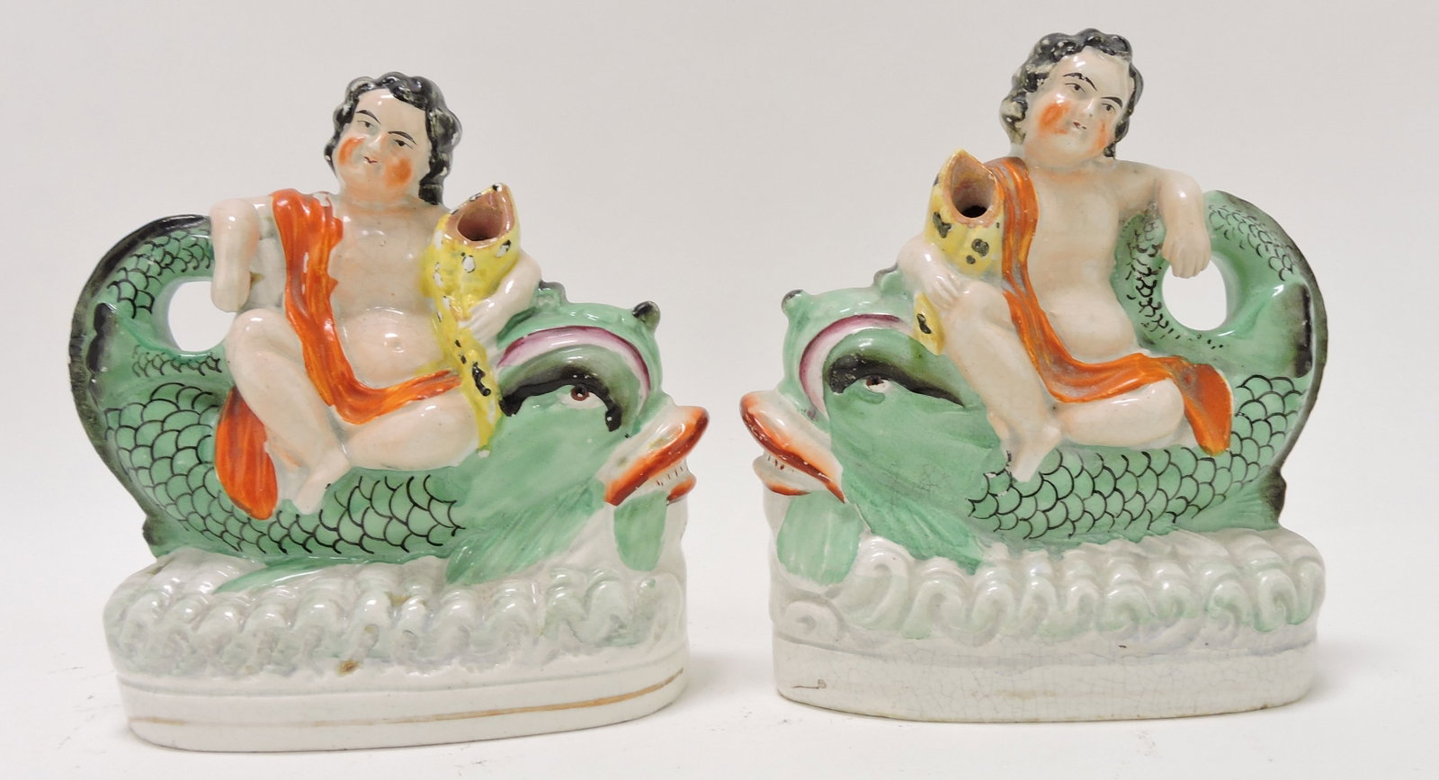 Staffordshire pair of putto with dolphin: figures, 6 1/2"