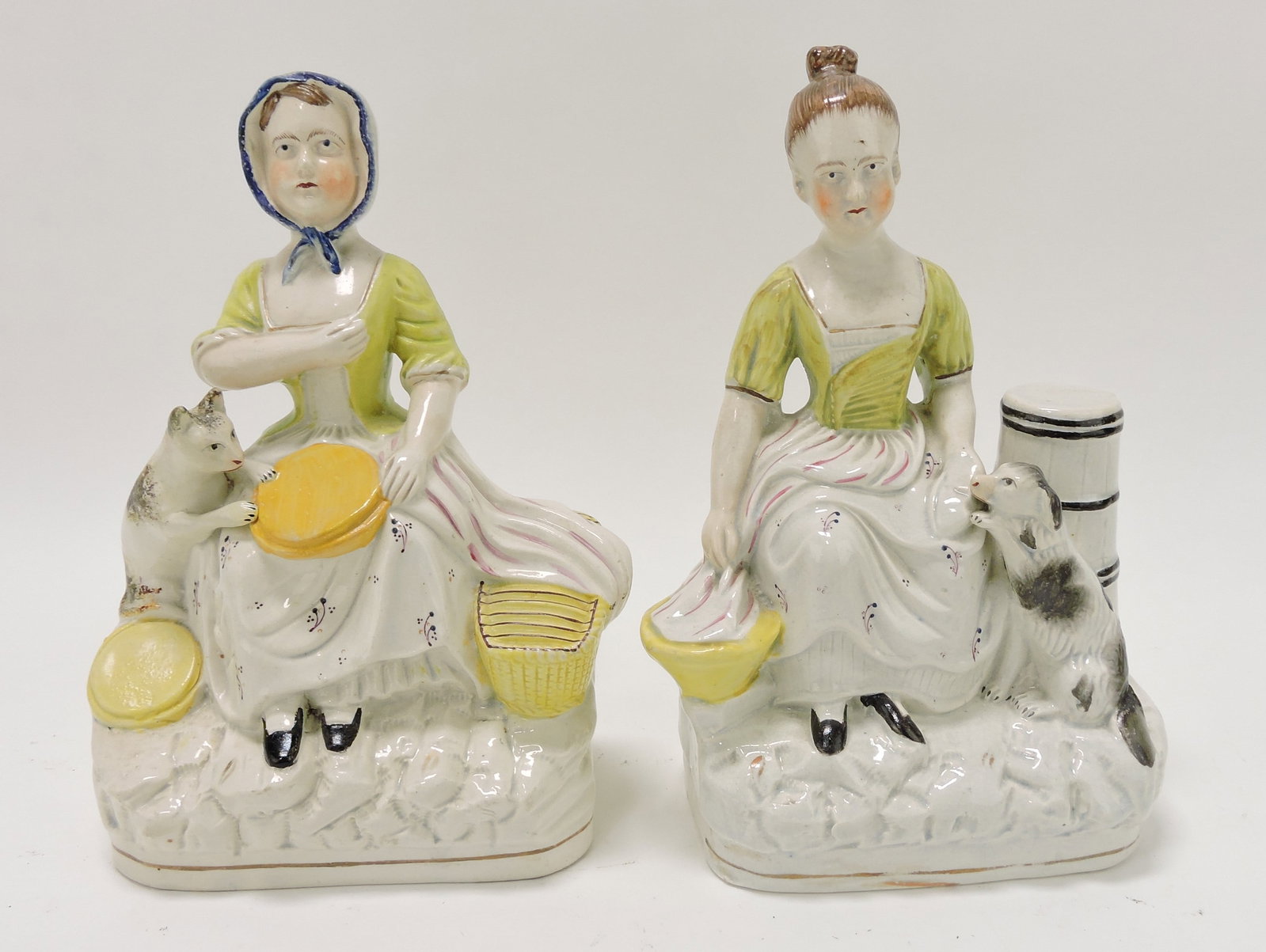 Staffordshire pair of lady figures with: dog and cat, 8 1/2"