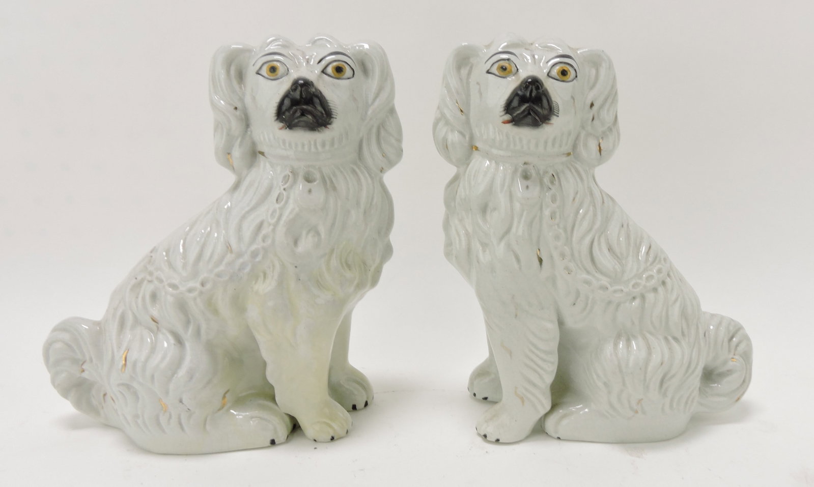 Staffordshire pair of dogs with free leg,: repair to leg of left dog, 9"