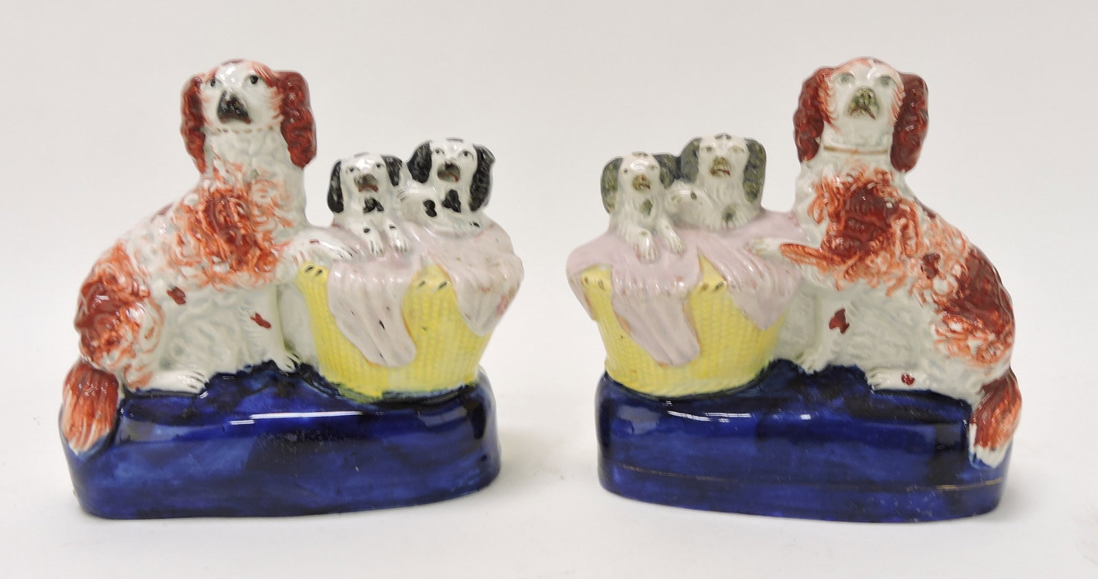 Staffordshire pair of dogs with pups: in basket on oval plinth, 6"