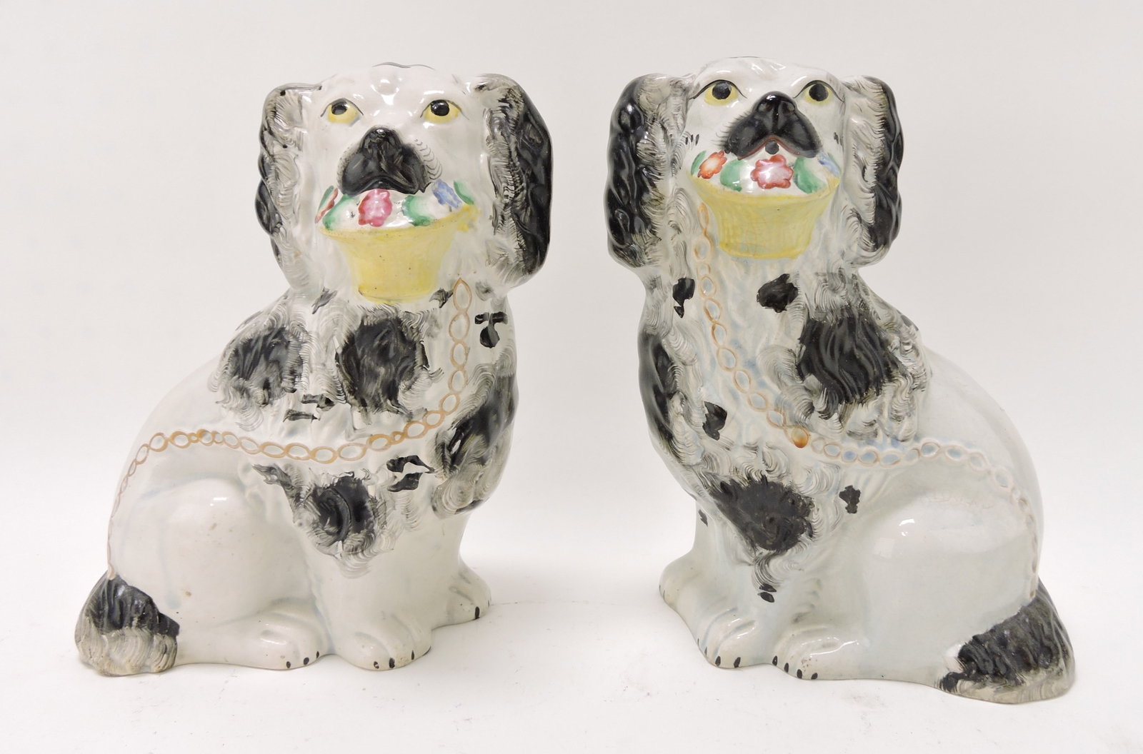 Staffordshire pair of large dogs with: flower basket, 9 1/2"