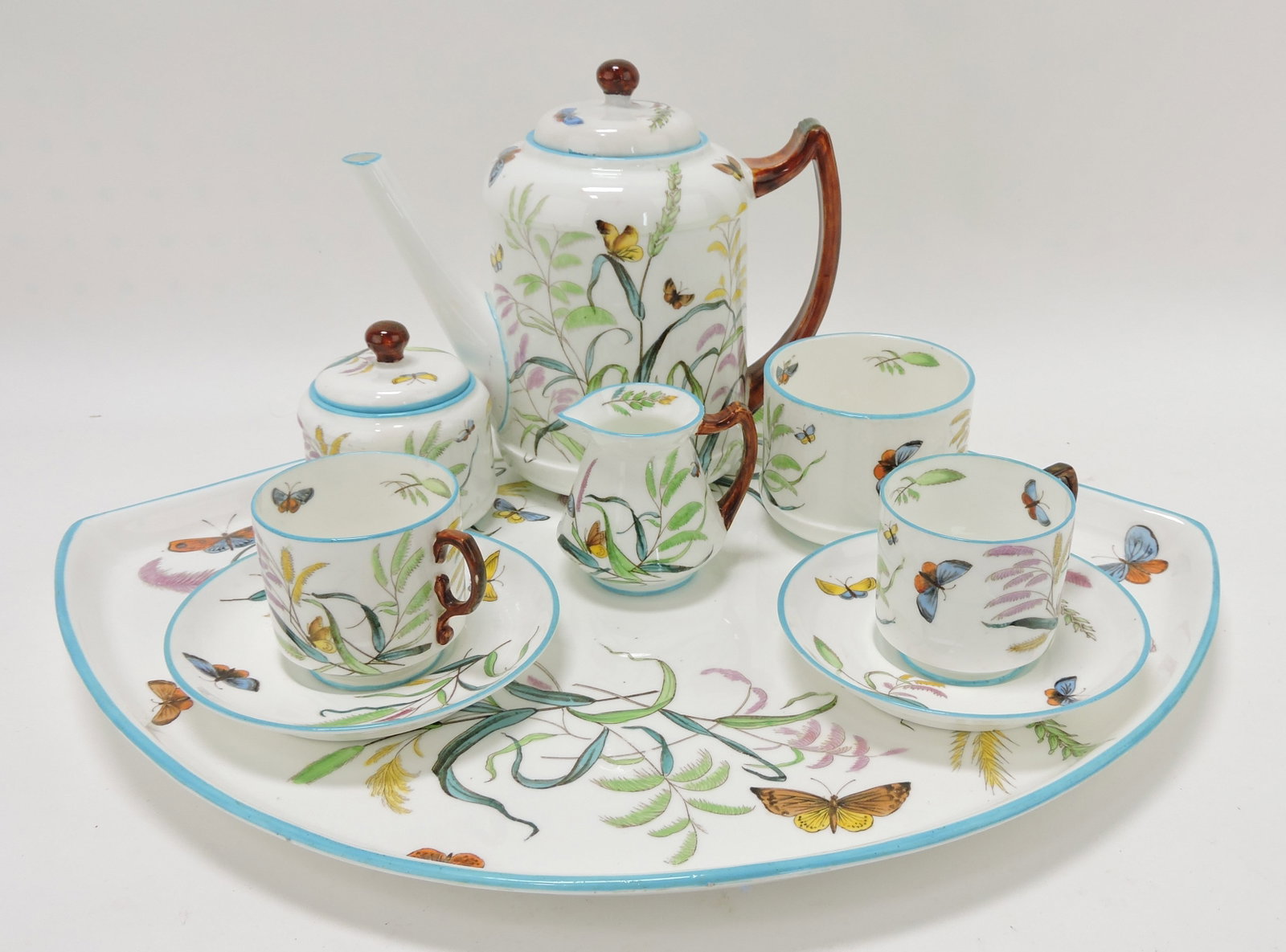 George Jones porcelain 9 piece: butterfly and floral tete-a-tete set with 17 1/2" fan shaped tray, teapot, cream, sugar, spooner, 2 cups/saucers