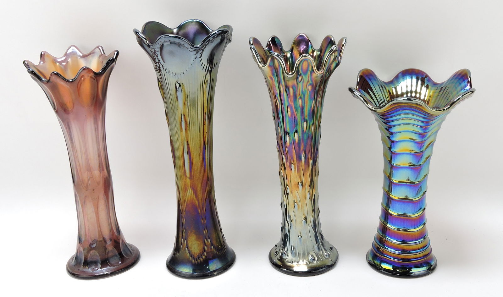 Amethyst carnival glass lot of 4 vases,: 9 to 11 1/2"