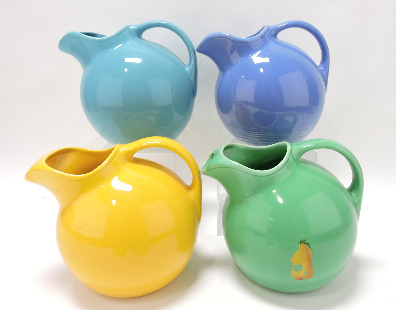 Harlequin lot of 4 service water jugs:: turquoise, mauve blue, yellow, green