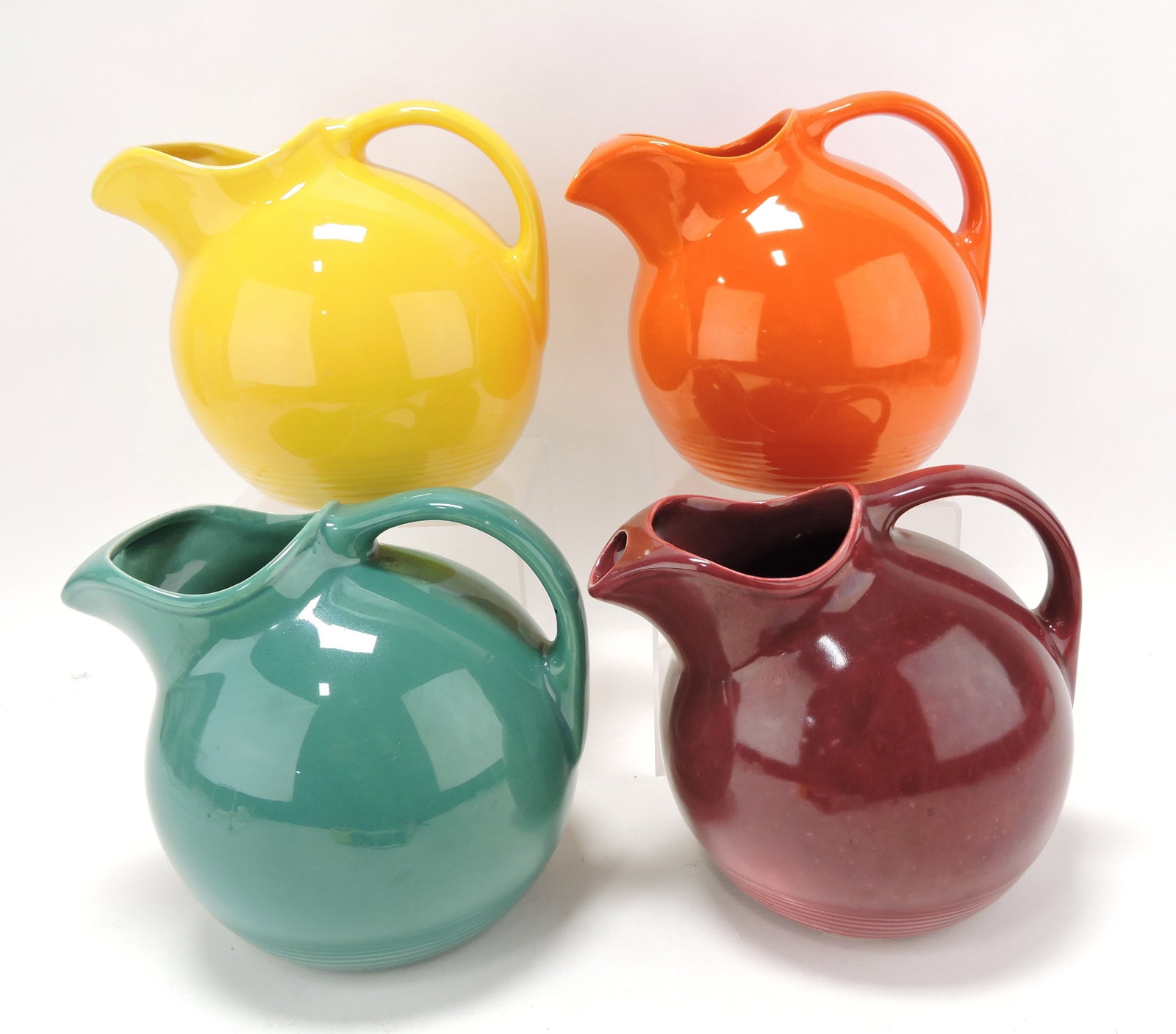 Harlequin lot of 4 service water jugs:: yellow, red, spruce green, maroon