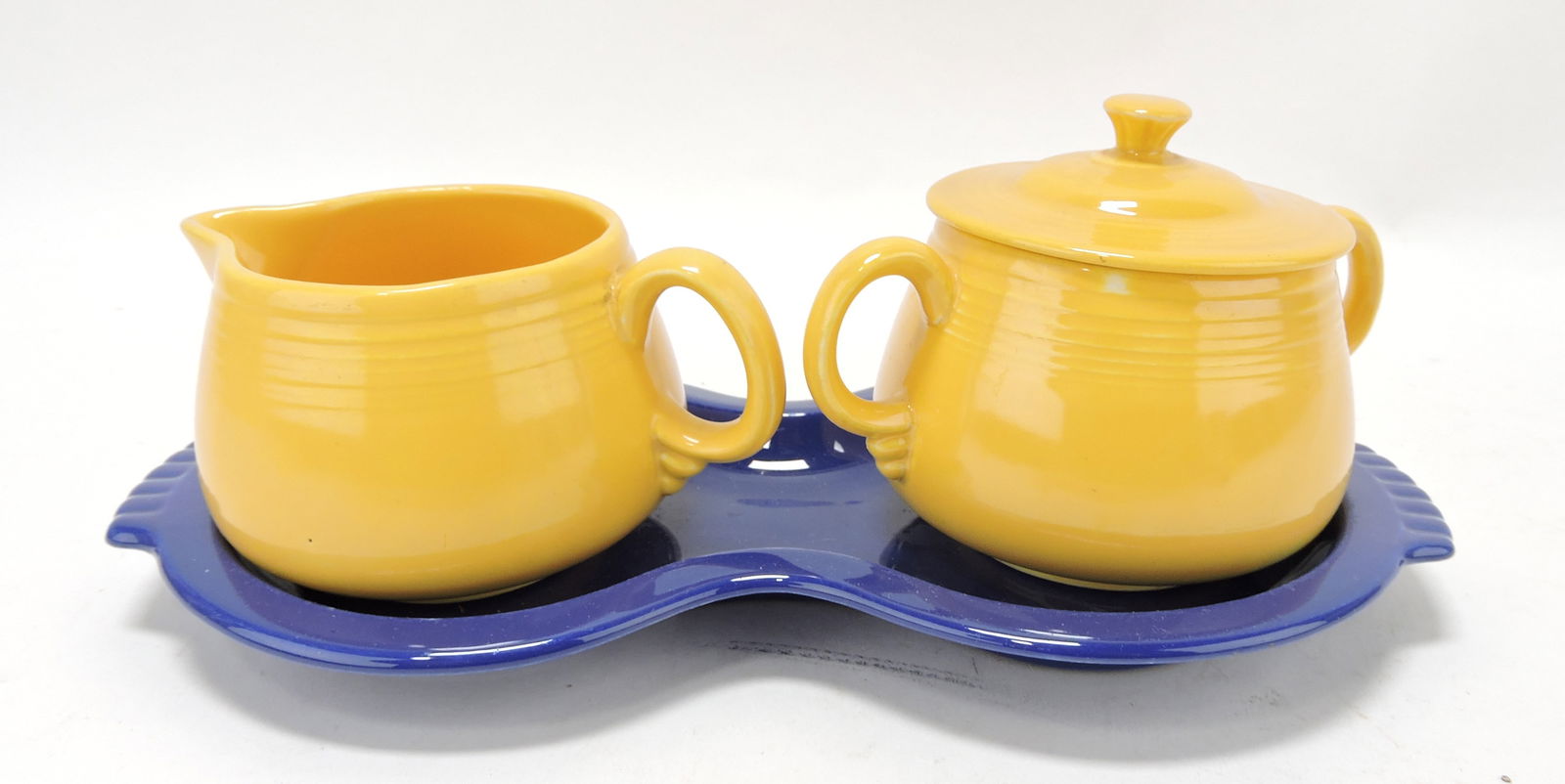 Fiesta cream, sugar, & tray set, yellow: creamer & sugar, cobalt figure 8 tray; nick to inside lid flange of sugar