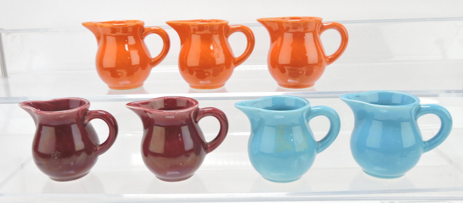 Harlequin lot of 7 individual creamers 2",: 3 red, 2 maroon (one chipped), 2 turquoise