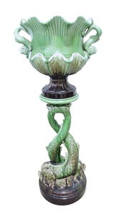 Monumental French majolica jardiniere: and pedestal in green/brown blended glaze, two entwined dolphins forming base with dolphin handled jardiniere, 50"h, 21"w
