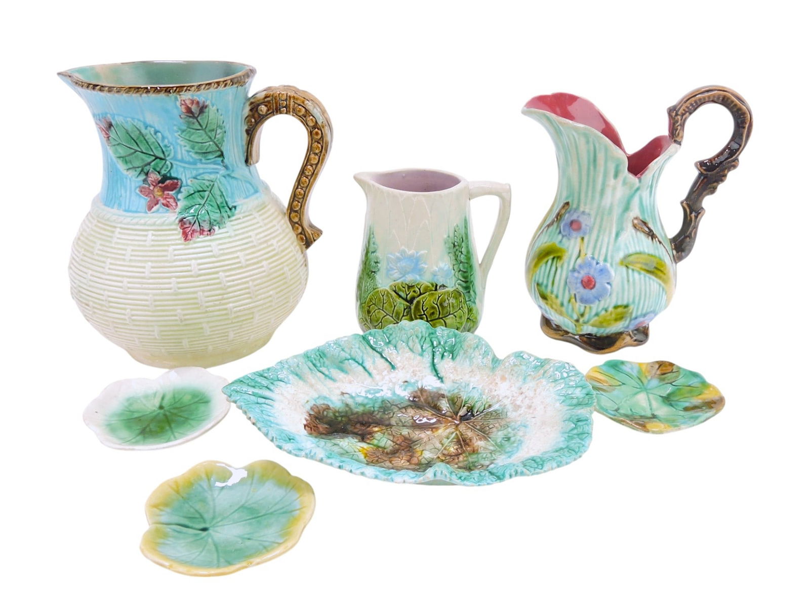 Majolica lot of 3 pitchers,: 3 butter pats, and begonia leaf, various condition