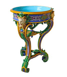 A rare monumental Minton majolica: table tripod jardiniere, model no.718 modelled by Baron Marochetti, the circular turquoise bowl, standing on three long scrolled legs, festooned with entwined foliage, to the top of each leg a mytholo