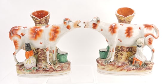 Staffordshire pair of cow spill vases with