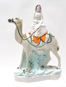Very rare Staffordshire figure of a woman on a camel,