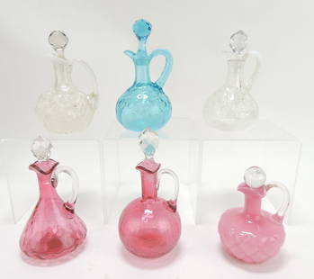 Lot of 6 cruets: Northwood opalescent: daisy & fern on apple blossom mold, blue and clear opalescent intaglio, cranberry thumbprint, cranberry crackle, and quilted phlox, 5" to 7"