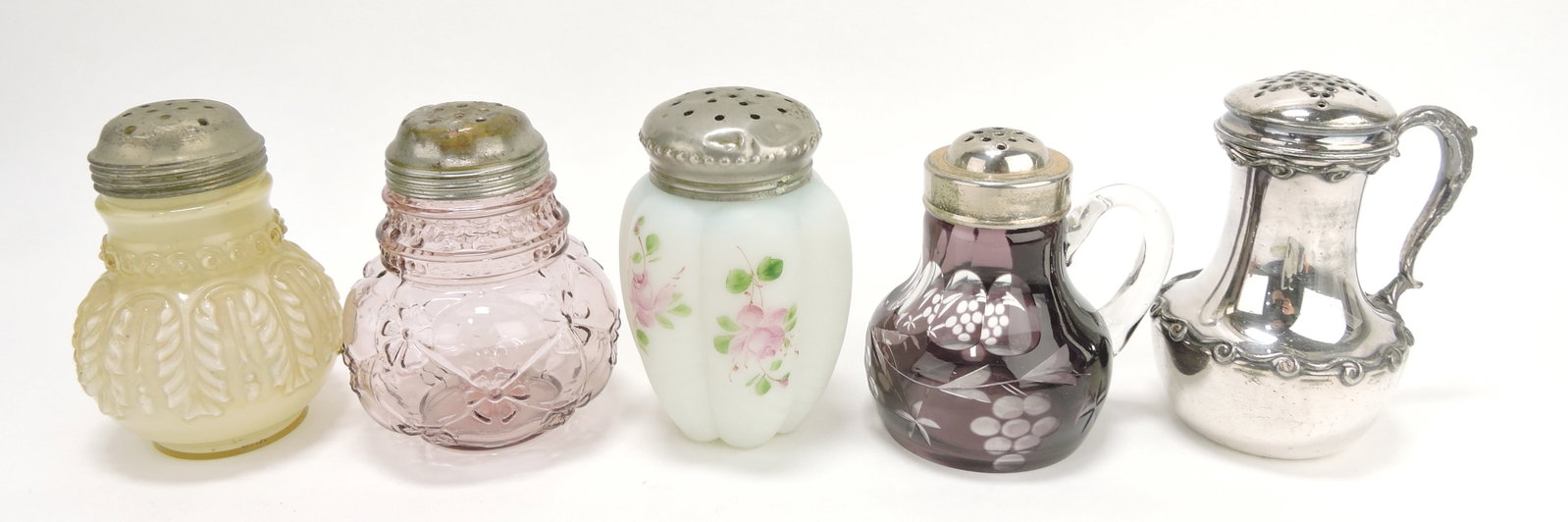 Lot of 5 sugar shakers:: Northwood leaf umbrella, Northwood quilted phlox, melon ribbed floral enamel, Bohemian amethyst cut to clear, and Wilcox silver plate, 4 1/4" to 5"