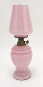 Pink cased glass miniature oil lamp,