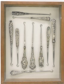 Frame of Victorian button hooks, some