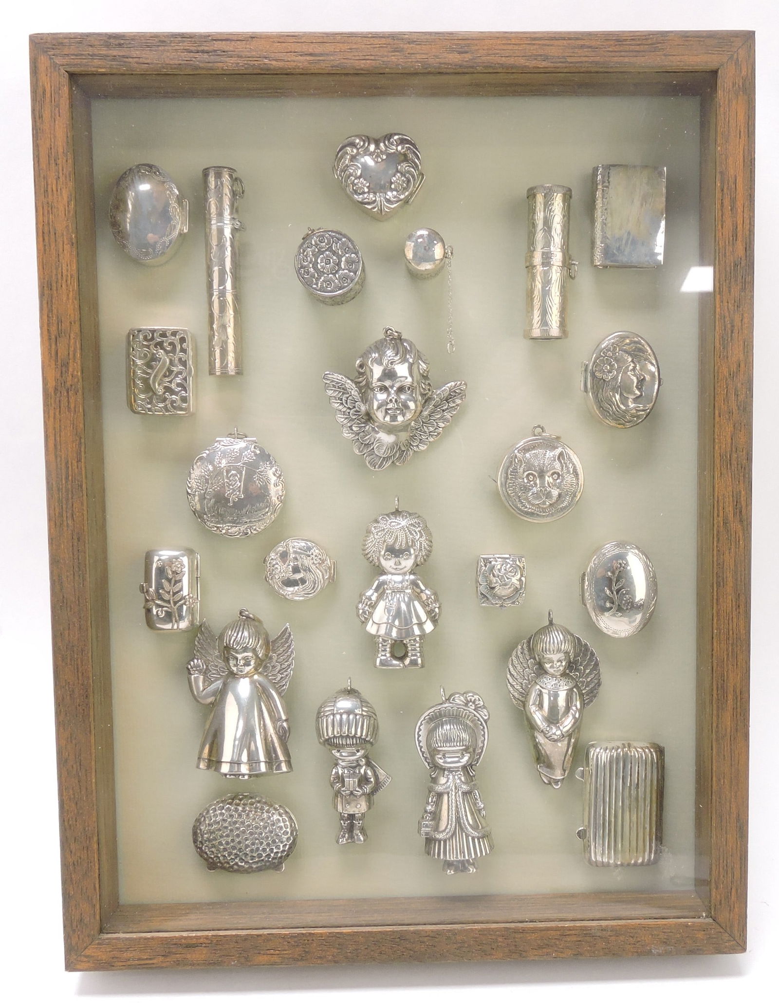 Frame of pill boxes, trinket boxes,: pendants and ornaments including sterling silver, 13 1/2"x9 1/2"