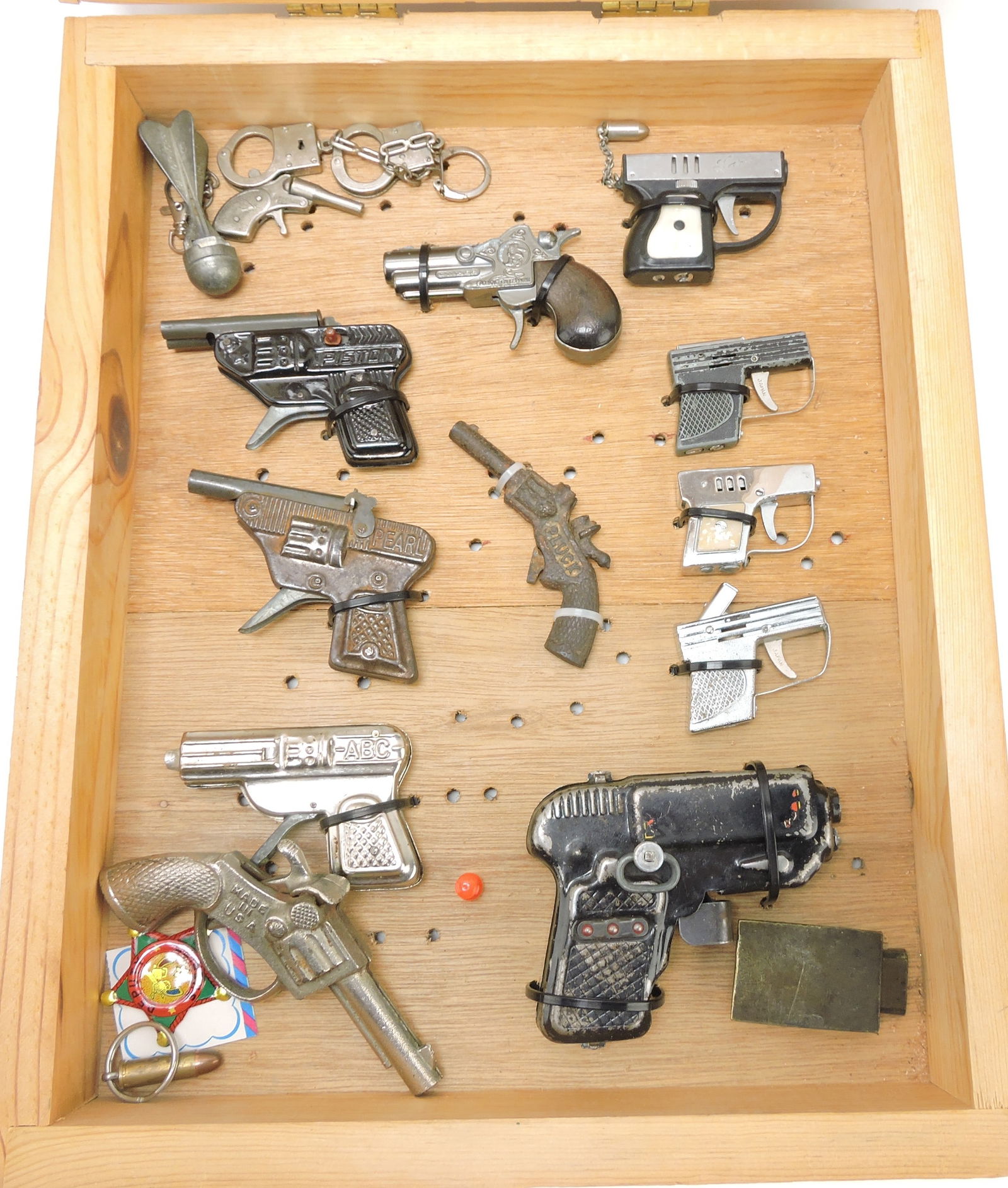 Frame of cap guns, lighters, and more,: 15"x12"