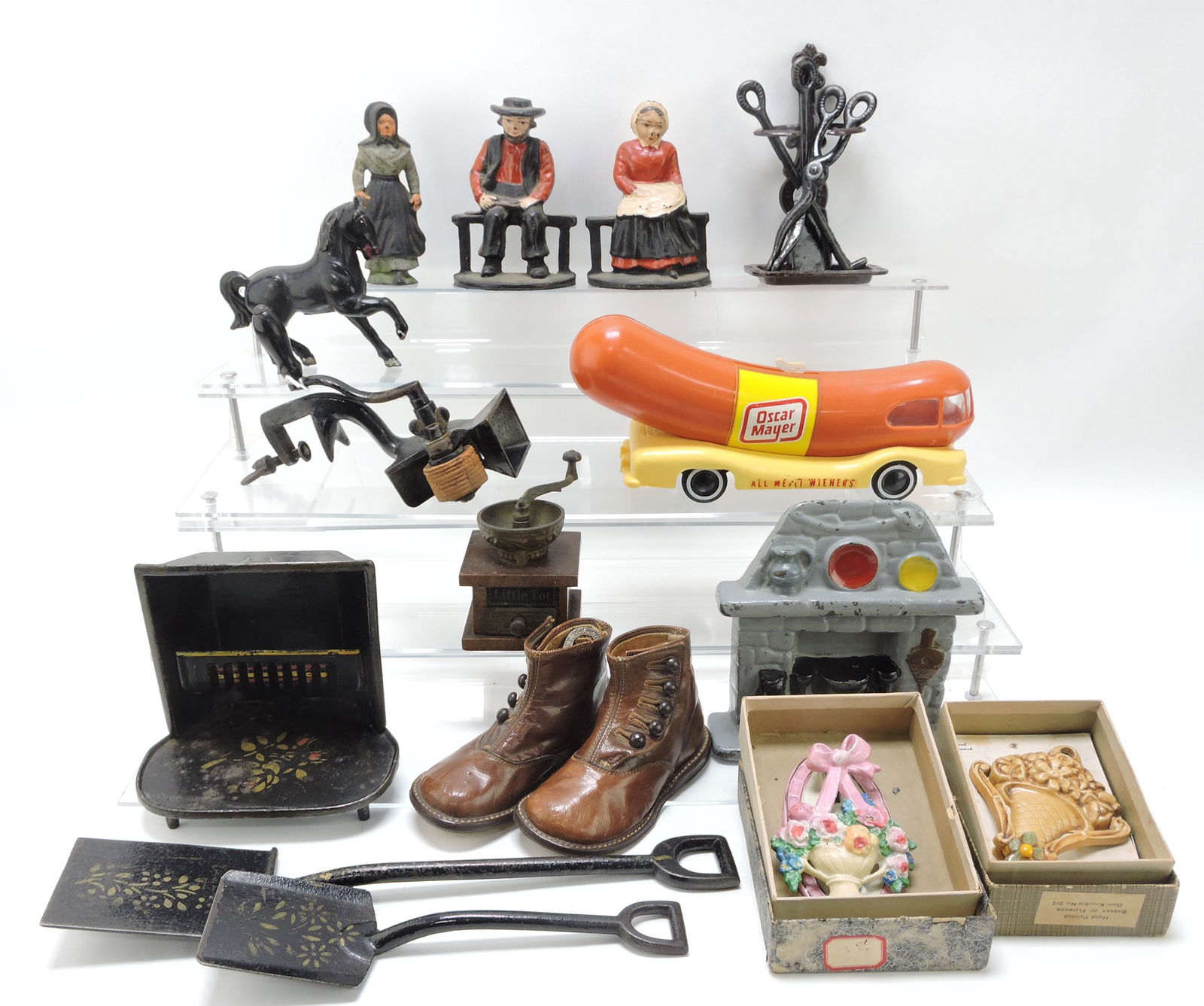 Lot of cast iron and other items:: bookends, horse bank, nutmeg grater, Oscar Mayer bank (plastic), coffee grinder, shovels, door knockers, and more