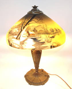 Reverse painted table lamp with: winter cabin on stream scene, 21"h, 16"d, paint loss to metal top