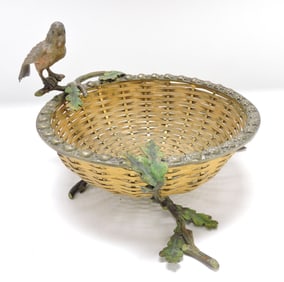 Bronze bird on branch woven basket