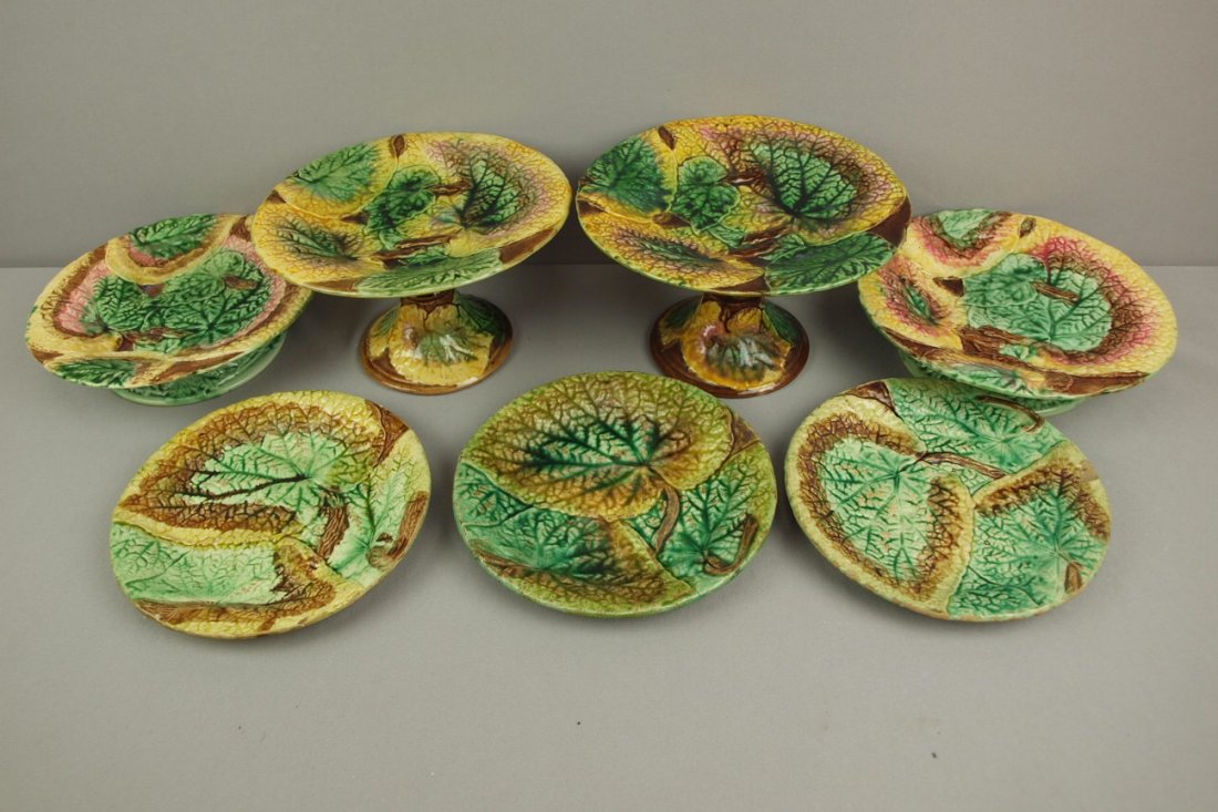 Majolica lot of 7 overlapping begonia items - 2 tall: Majolica lot of 7 overlapping begonia items - 2 tall cake stands, 2 low cake stands and 3 plates, various condition