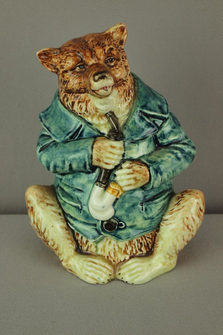 Continental majolica figural humidor in the form of : Continental majolica figural humidor in the form of a bear with blue smoking jacket smoking pipe, 6", professional repair to base rim