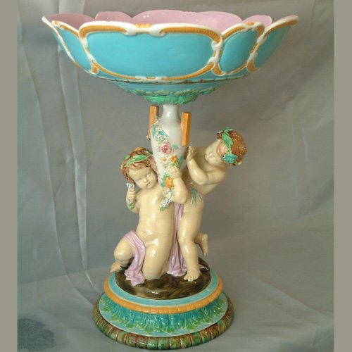 GEORGE JONES majolica table center comport with 2 put: GEORGE JONES majolica table center comport with 2 putti with vase supporting bowl, great color and detail, 15 1/2"h, 11"d