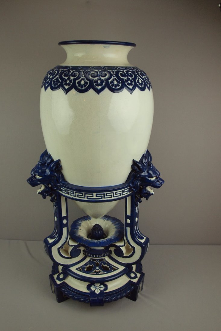 MINTON early blue and white majolica floor vase by : MINTON early blue and white majolica floor vase by Christopher Dresser in the form of an amphora vase supported by tripod stand with dragon heads, professional repair to high points and edges, 37 1/2"