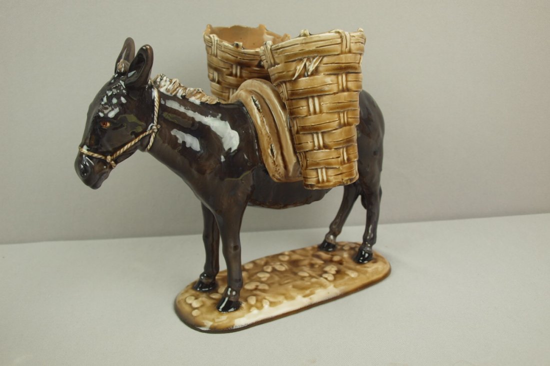 DELPHIN MASSIER French majolica donkey with baskets : DELPHIN MASSIER French majolica donkey with baskets figure, 9"h, 10 1/2"l, professional repair to basket rims and base rim