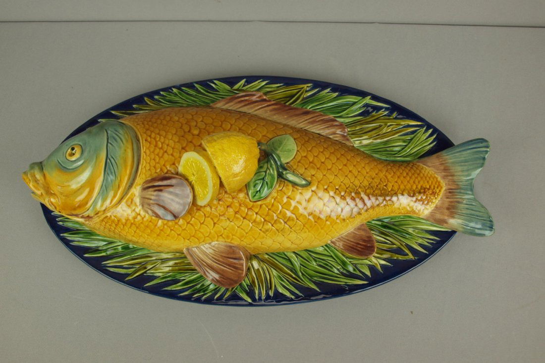 MINTON rare majolica carp tureen with golden colored: MINTON rare majolica carp tureen with golden colored carp with lemon handle atop a bed of seaweed on cobalt base, shape no. 1979, 23"l, 12"w, 7"h, professional repair to lemon and one fin, ref: Majoli