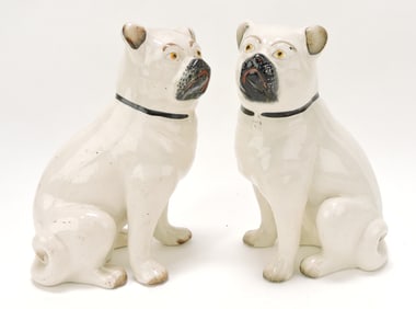 Staffordshire pair of seated pug dogs,