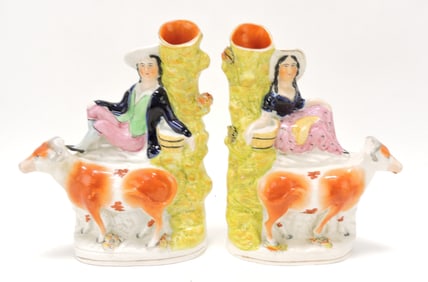 Staffordshire pair of spill vases with cows