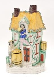 Staffordshire figural of boy kissing girl in