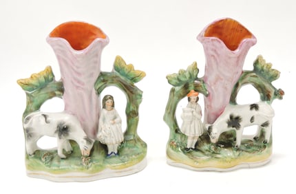 Staffordshire pair of cow spill vases,