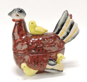 Staffordshire hen on nest with chicks,