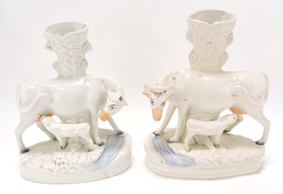 Staffordshire pair of cow spill vases,