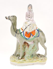 Staffordshire figure of lady riding camel,