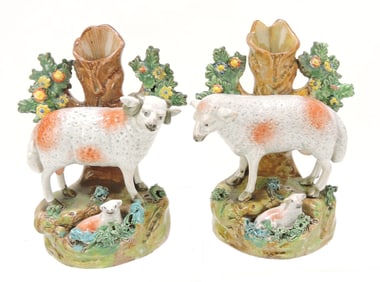 Staffordshire pair of sheep spill vases,