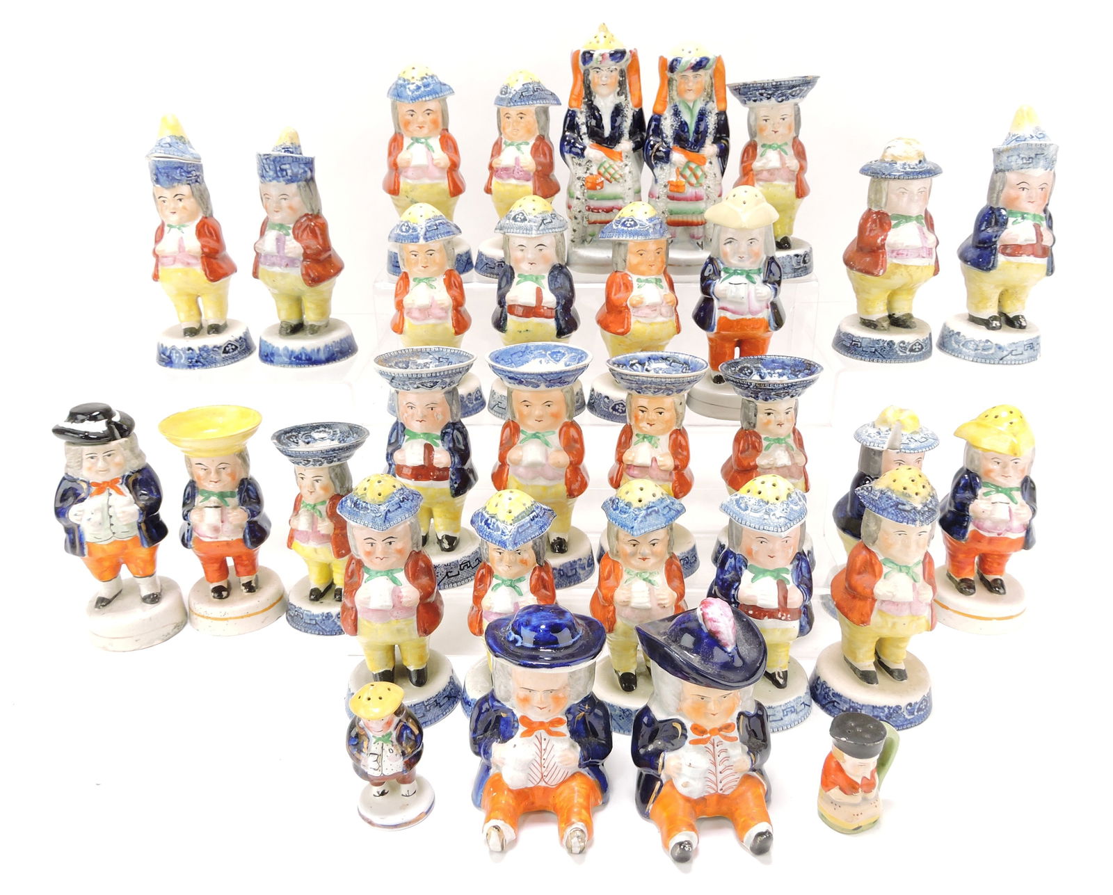Staffordshire lot of 31 toby shakers,: egg holders, syrups, and mustards, various condition