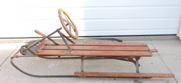 Wooden sled with steering wheel and