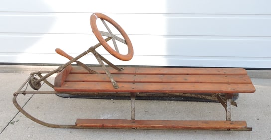Wooden sled with steering wheel and