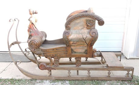 Wooden sled with lady mast head,