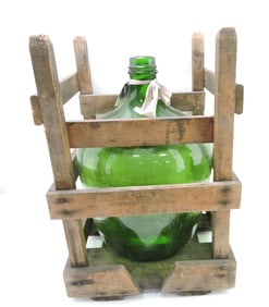 Large green glass carboy bottle in
