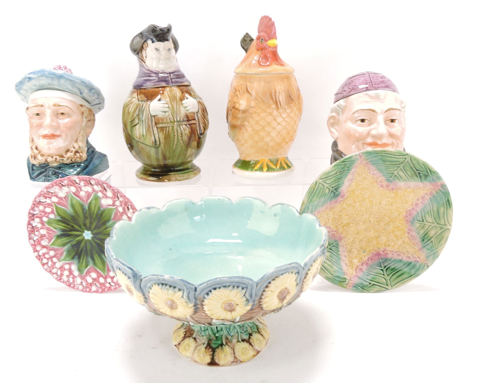 Majolica lot of 7 items - 2 humidors,: 2 plates, Etruscan comport, toby jug, and contemporary rooster stein, 6" to 9", various condition