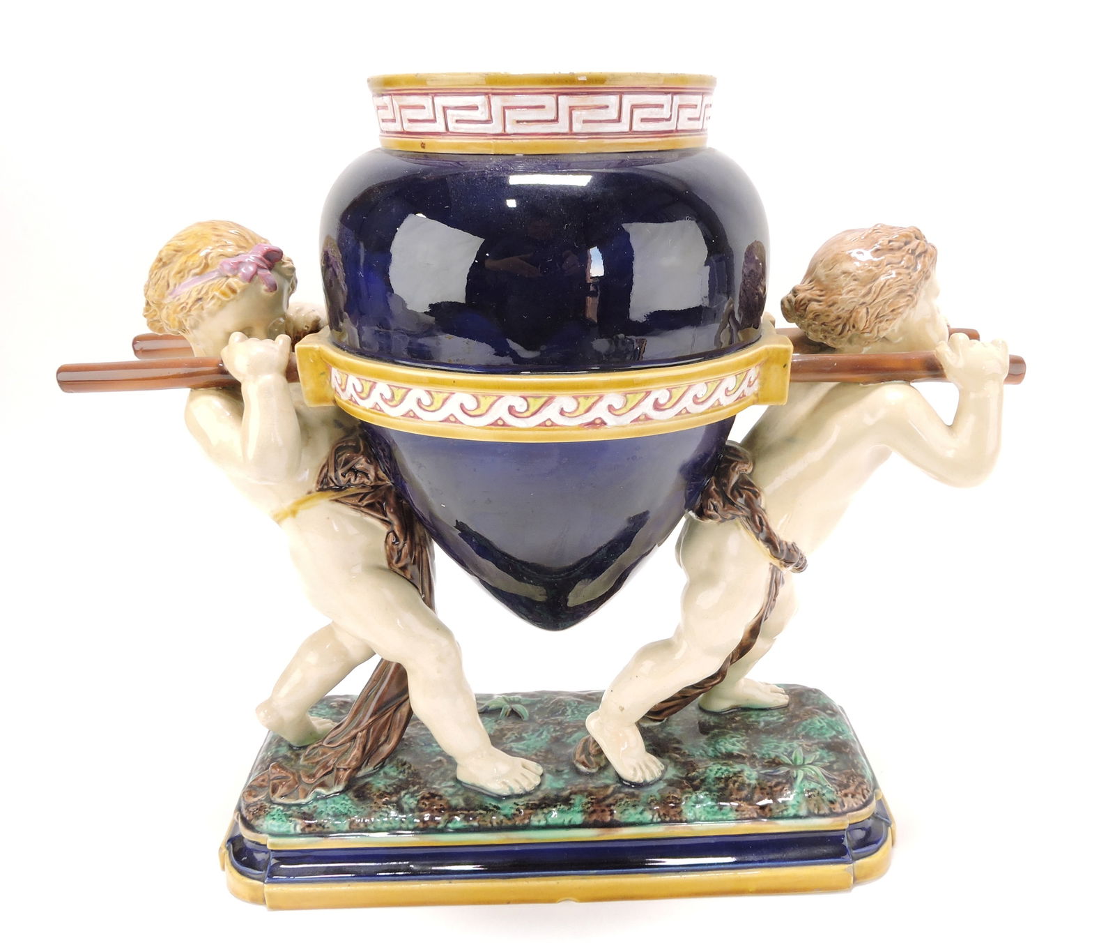 Minton majolica figural vase with pair of: putti supporting and amphora vase, professional repair to rods and putti, 14"h, 16"w